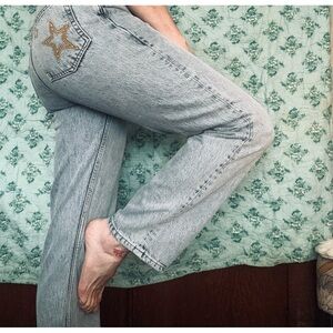 High rise button up light blue jeans. Straight leg.